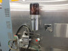 Blue M FR-256PB-1 rear humidifier detail — cylindrical water supply/humidifier bottle, solenoid valve assembly, green tubing connections, red stop button, and circular humidity gauge on chamber rear panel