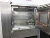 Blue M FR-256PB-1 chamber interior fully open — stainless steel walls with perforated side panels, wire rack shelf, inner access port with orange gasket seal