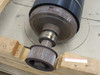 Detail view of the toothed drive pulley and keyed shaft end of the press roll on wooden pallet supports