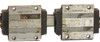 Two THK YN8K1495-B bearing block carriages side by side off the rail, labeled -1 and -2, showing grease buildup and surface oxidation