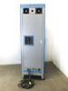 Unholtz-Dickie MA250-110 control cabinet rear – dual top-mounted cooling fans, rear vent panel, side connector panel, and detached power cable on floor