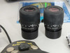 Pair of Leica 10445111 eyepieces with diopter adjustment rings, shown side by side with Saitek Action Pad and Finetech software CD in background