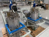 Riber Jet 40K dual stainless steel selenium reservoir vessels on blue mounting frames with actuators and vacuum fittings — close-up view