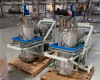 Riber Jet 40K dual selenium reservoir vessels on white steel frame close-up showing stainless flanged bodies, green tubing, and blue base plates