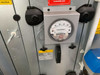 HYD11-100 cabinet door detail showing Magnehelic differential pressure gauge and filter section warning labels
