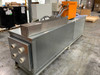 Deltatherm HYD11-100 side view showing full-length stainless duct cabinet with orange chiller unit mounted on top at rear