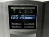 APC SMT1500I LCD display close-up showing Load 0% and Battery 77% charge with navigation buttons