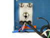Johnson Matthey HP-100 rear gas connection panel close-up — FEED and PURE stainless compression fittings, 110V voltage label, and multi-conductor wiring harness
