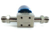 Flowlink Gaz valve bottom and rear view showing stainless steel valve block with serial number 1146489, four mounting holes on underside, and compression fitting ports on each end