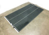 SoloPower SP3L-180 180W flexible solar panel laid flat on floor — full top view showing dark CIGS cell surface with white border frame and three cell columns