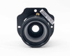 LCD projector concave lens with focal adjustment – straight-on front view showing lens aperture and brass adjustment screws on mounting plate