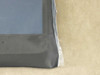 Close-up of Xunlight XRD12-100 flexible solar panel corner showing ETFE surface texture, laminate edge seal, and translucent protective film