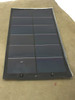 Xunlight XRD12-100 100W flexible solar panel laid flat, front cell surface view showing multiple amorphous silicon cell sections and two bottom solder tab connectors