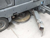 Nilfisk-Advance 3800 underside – worn disk scrub brush visible with detached squeegee/side deflector blade on floor