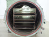 Interior of cylindrical entry/antechamber tube – showing multi-shelf stainless steel rack insert with four shelves and orange rubber door seal ring