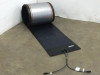 Uni-Solar PVL-136 136W flexible solar panel partially unrolled on floor with MC3 output cables visible