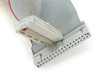 Close-up of ribbon cable end connectors — two IDC headers with gray flat ribbon cable and red stripe conductor