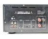 Integra ADM-2.1 rear panel left section close-up showing GND terminal, RCA audio out/in loop jacks, input level pot, trigger mode switch (Audio/Off/12V), 12V trigger in jack, and L/R speaker binding posts