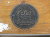 Brass Ertel Werke München maker's medallion on top of wooden case with serial number 32697 below