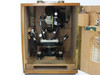 Interior of wooden case with theodolite stored, showing door-mounted accessory holders and original spec label