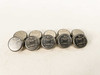 Lot of 10 Dallas Semiconductor DS1982U-F5 iButton stainless steel disk EPROM data carriers arranged in two rows on white surface