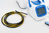 Close-up of EMTEK V100 sampler front panel touchscreen display and yellow-black RS2 sampling cable coiled beside unit