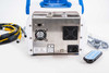 EMTEK V100 rear panel close-up showing rating label, CE mark, dual cooling fans, IEC power inlet, USB and RJ45 ports, and wireless remote