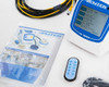 EMTEK V100 front panel close-up with RS2 label on LCD screen, EMTEK product brochure and remote control visible