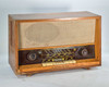 Grundig 3025/S Zauberklang AM FM tube radio — three-quarter front-left view showing wood veneer cabinet and speaker grille