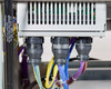 Internal component bay showing circuit board assembly with edge-connector ribbon cables, three large black cable gland conduit fittings, and DO NOT OPEN HIGH PRESSURE warning label