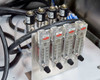 Dwyer rotameter flow meter bank – four vertical LPM Air flowmeters labeled Delay, N2, Gas 1, Gas 2 with black knob needle valves; four solenoid valves mounted above