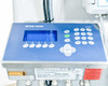 Mettler Toledo IND560 scale terminal close-up — blue LCD display, numeric keypad, navigation buttons, warning labels on housing