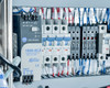 Allen-Bradley 1606-XLS power supply inside control panel — 24V DC / 5A output, AC 100–240V input, with adjacent circuit breakers and terminal wiring