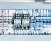 Control panel interior detail — relay bank with CR 500180 and CR 500270 labels, terminal block rows, blue and red wiring, DIN rail mounted components