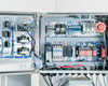 GES Automation Technology control panel interior — contactors, terminal blocks, Allen-Bradley components, relay bank, wiring