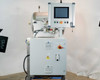 Left side view of OTC-3.0AL system showing vacuum chamber, NI TPC-2230 touchscreen control panel with emergency stop button, and Hoffman electrical enclosure below