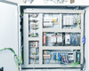 Hoffman CSD20168LG electrical enclosure interior showing DIN rail mounted circuit breakers, contactors, terminal blocks, and wiring harness — full panel view