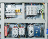 Electrical enclosure detail showing Eaton circuit breakers, three-phase contactors C42 and C43, and PULS DIN rail power supply