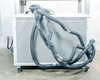 Rear of Opti Temp chiller unit showing insulated black process hoses draped over cabinet with perforated steel panels