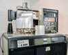 CHA Industries SEC-600 deposition chamber open — internal evaporation fixture, substrate holder, and e-beam assembly visible on cabinet top