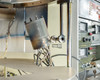 CHA Industries SEC-600 e-beam gun assembly — cylindrical electron beam gun tilted and mounted inside the open deposition chamber