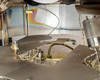 CHA Industries SEC-600 internal deposition assembly — shutter plate, substrate stage, ion source arm, and thin-film iridescent residue on interior walls