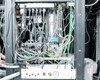 CHA Industries SEC-600 internal cabinet view — dense wiring harness, plumbing lines, pressure gauge, valves, and subsystem modules behind rear access panel