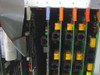 VMX D.I.A.L. card cage close-up – slots 2 through 7 showing voice/line cards with RJ modular connectors and color-coded tabs