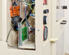 Grumbach incubator internal wiring close-up showing wiring from green PCB, orange component, coiled cable, and right-side panel with knobs and circular dial