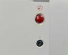 Lumenis Novus Varia front panel close-up showing red emergency stop button with STOP label and key switch in off position below