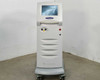 Lumenis Novus Varia Multicolor Photocoagulation Laser System – front view showing touchscreen display, laser warning indicator, and red emergency stop button on white floor console with casters