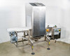 CEIA THS/MS21 food grade conveyor metal detector — 3/4 front-left view showing full system with stainless steel detector head, white conveyor belt, SEW drive motor, and control panel