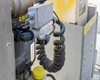 Easy Lift Equipment RCR70048LRCRSP-S – close-up of hydraulic pump assembly, coiled hose, and electrical junction box on mast