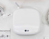 Top view of LG EnerBox 2 HGQQMSD10 white gateway unit with Wi-Fi antenna and LG logo, surrounded by accessories